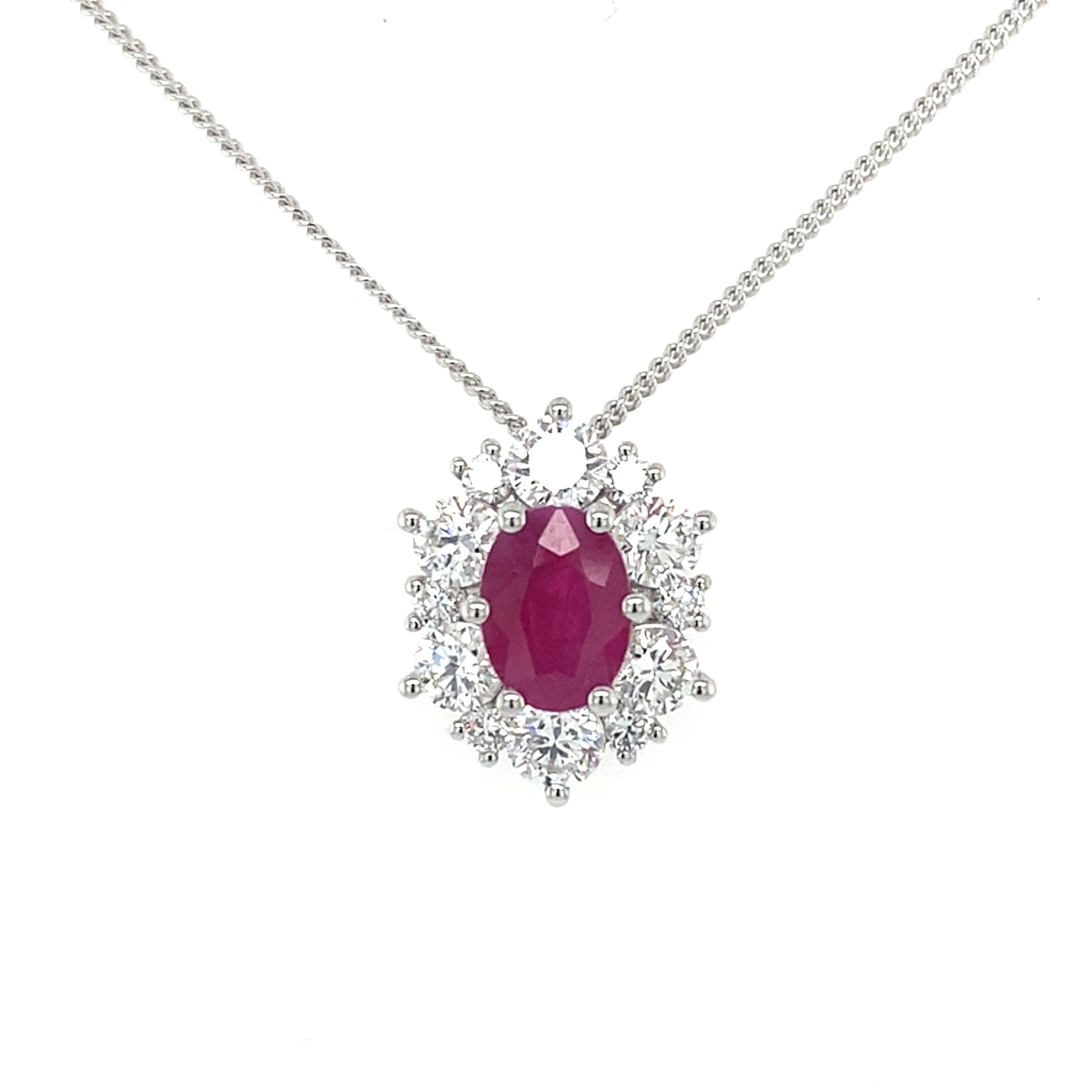 Oval shaped ruby and round brilliant cut diamond cluster style pendant Gardiner Brothers