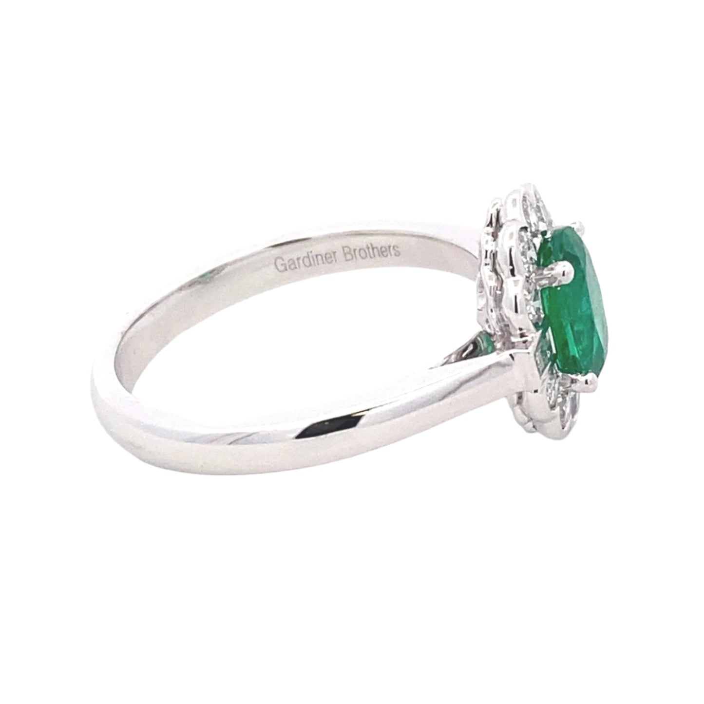 Oval emerald and diamond fancy cluster style ring Gardiner Brothers