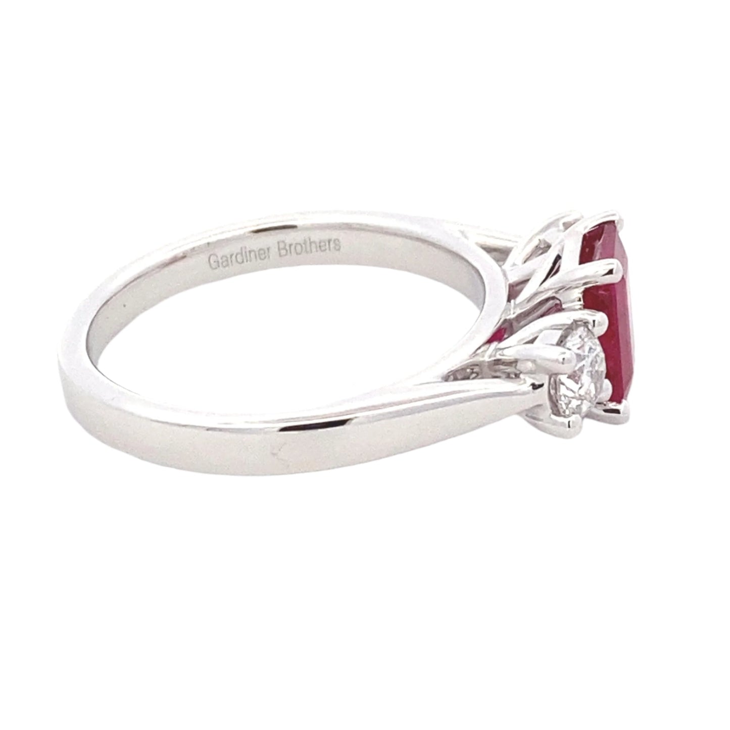 Octagonal Ruby and round brilliant cut diamond 3 stone ring Gardiner Brothers
