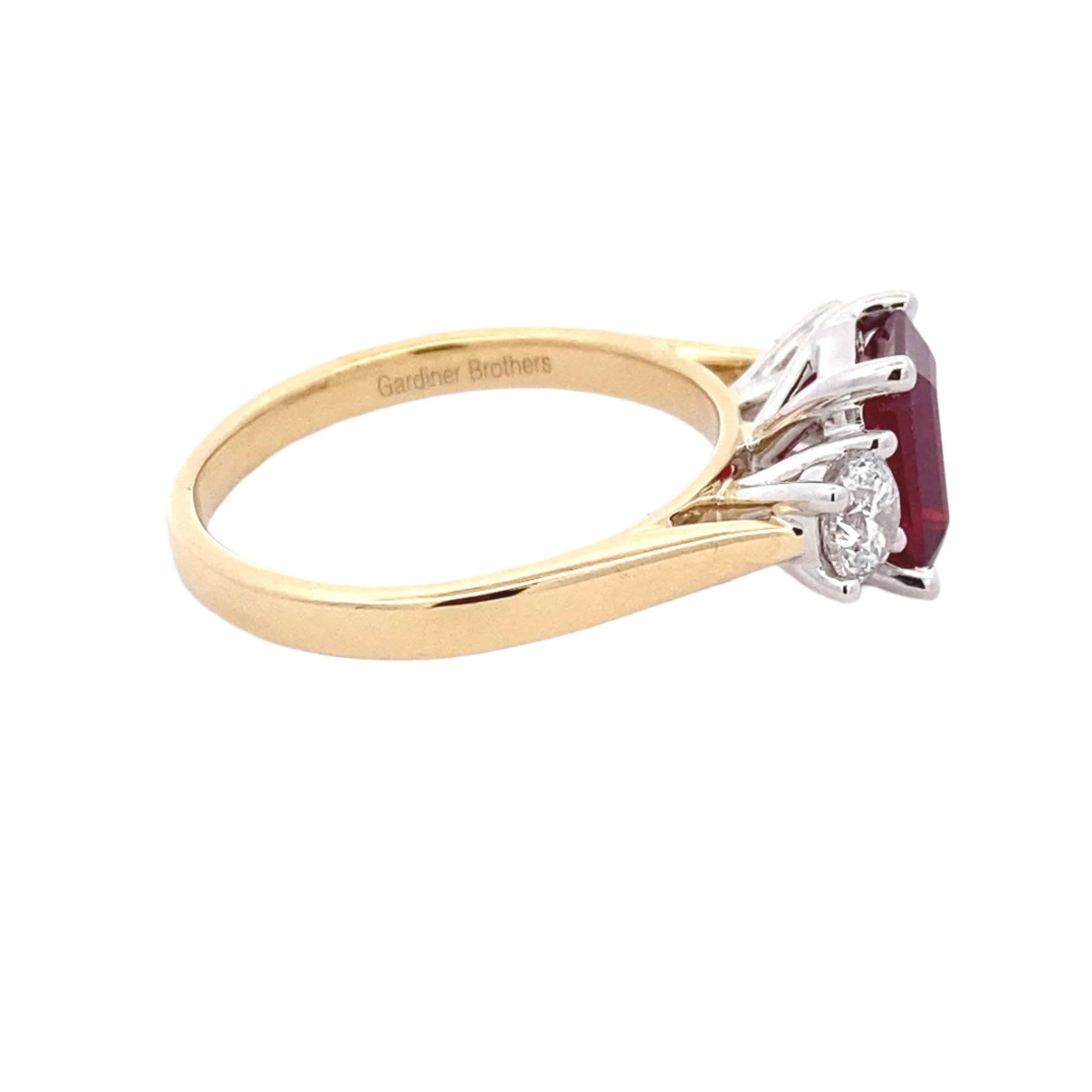 Octagonal Ruby and round brilliant cut diamond 3 stone ring Gardiner Brothers