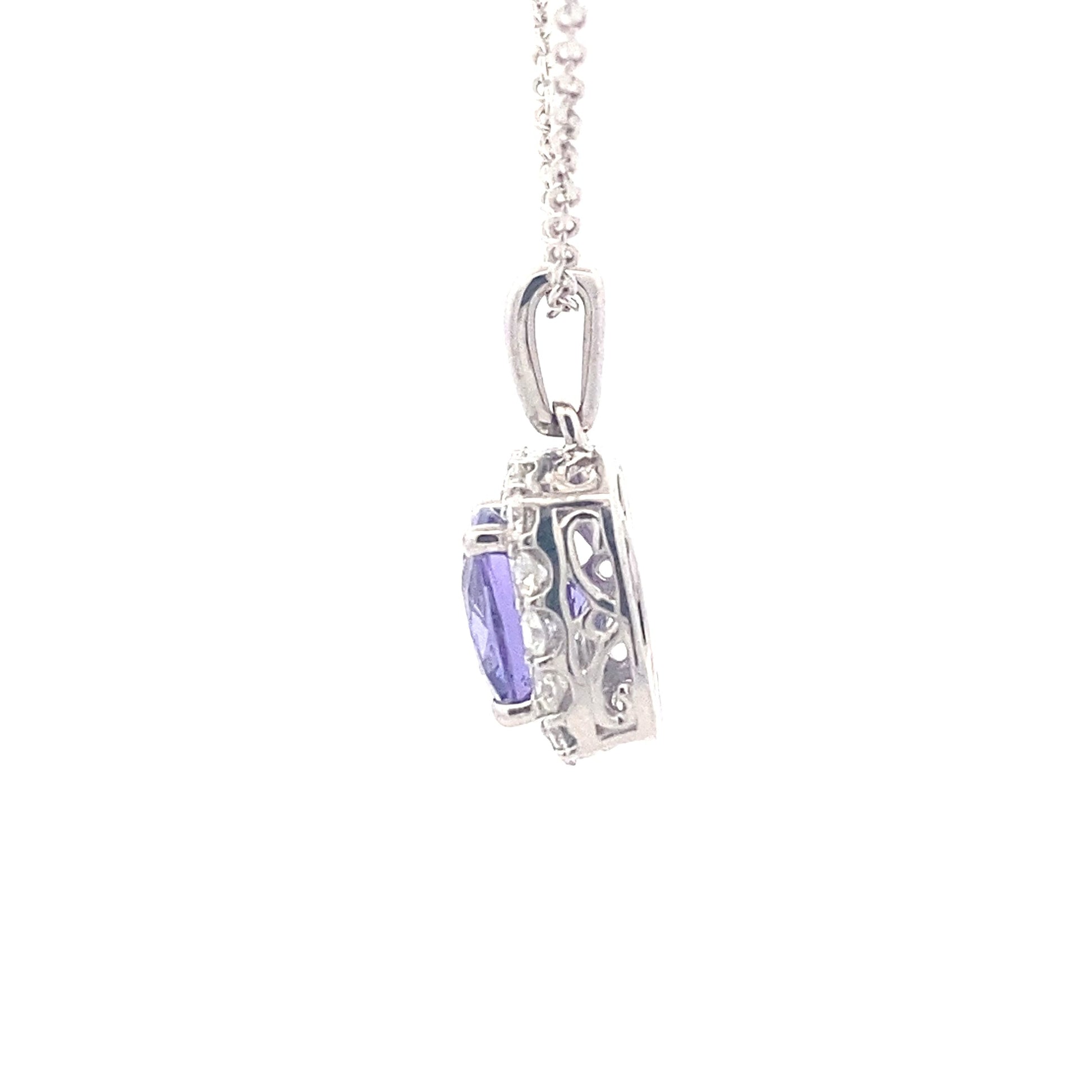 Cushion shaped Tanzanite and round brilliant cut diamond halo pendant Gardiner Brothers