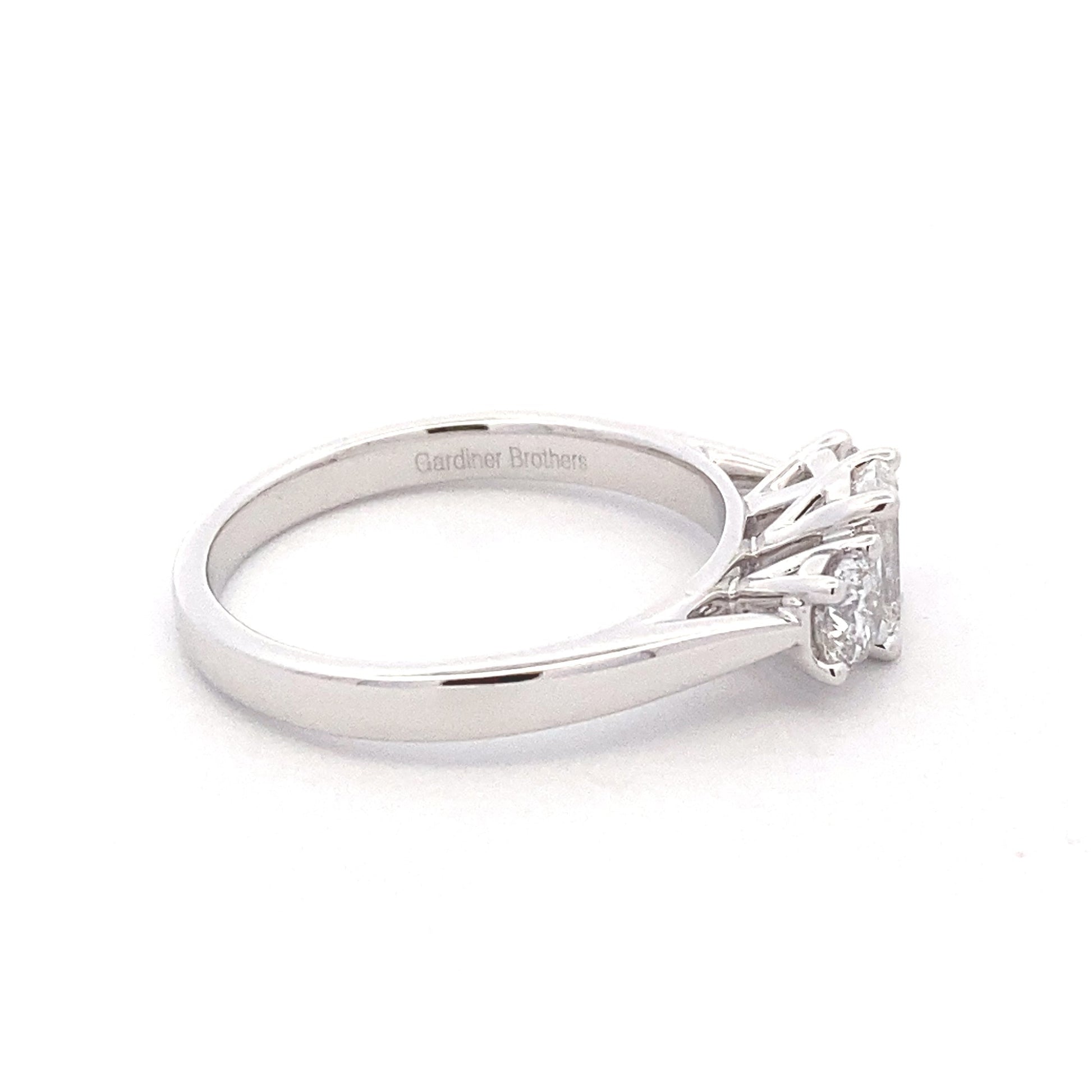 Platinum Emerald and round brilliant cut diamond 3 stone ring - 1.00cts Gardiner Brothers