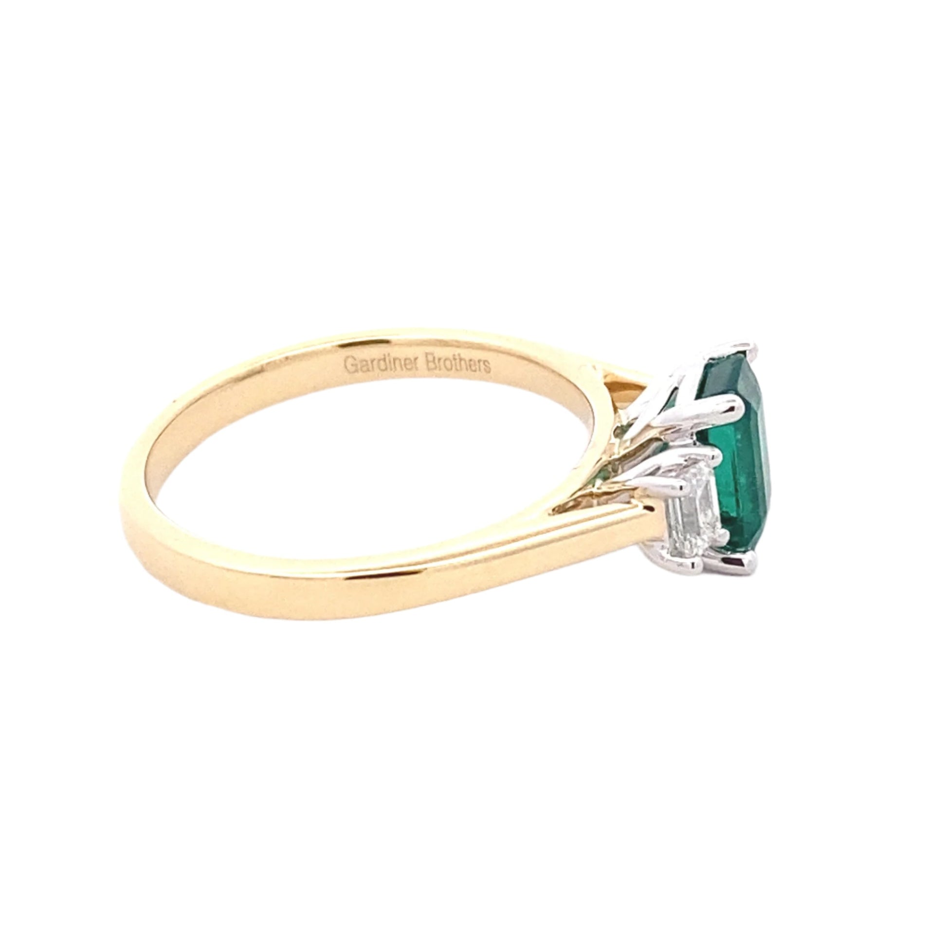 Octagonal emerald and emerald cut diamond 3 stone ring Gardiner Brothers