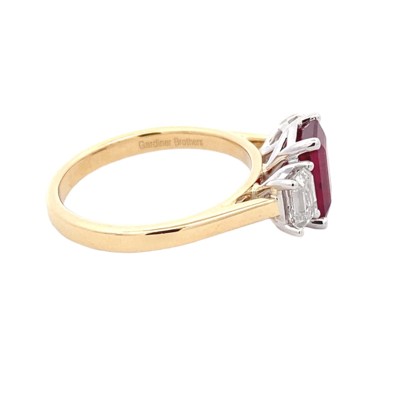 Octagonal Ruby and emerald cut diamond 3 stone ring Gardiner Brothers