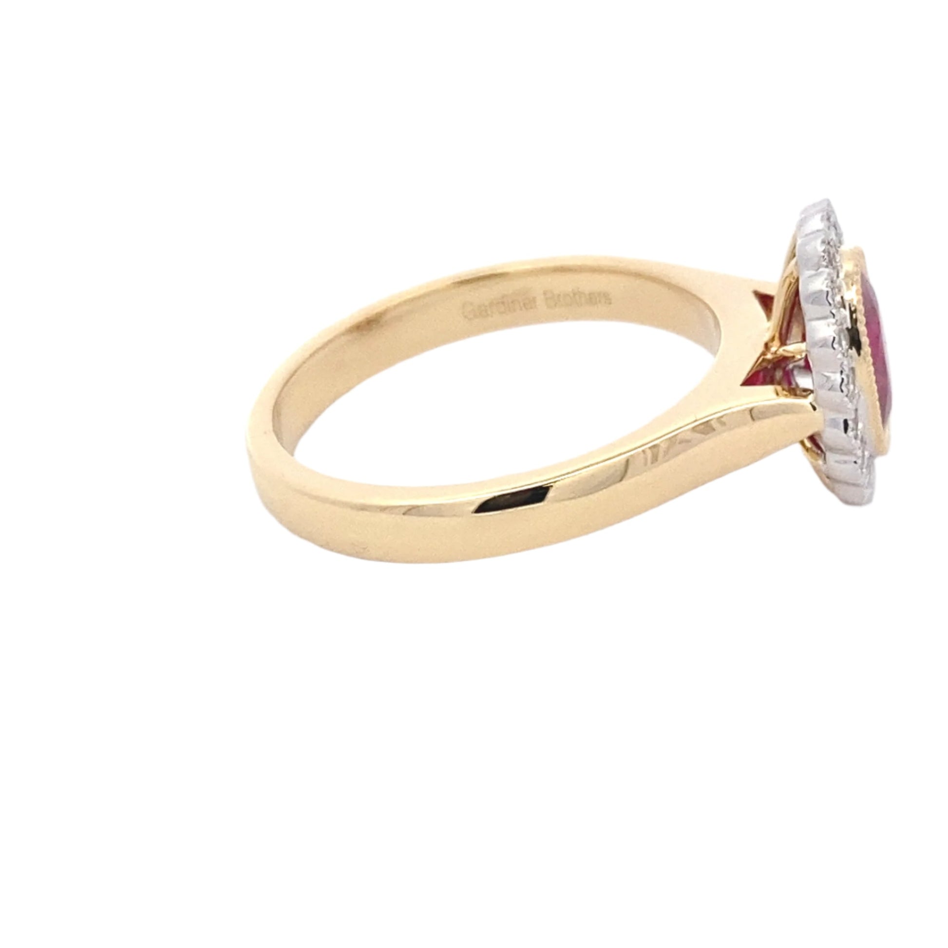 Oval ruby and round brilliant cut diamond vintage style cluster ring Gardiner Brothers