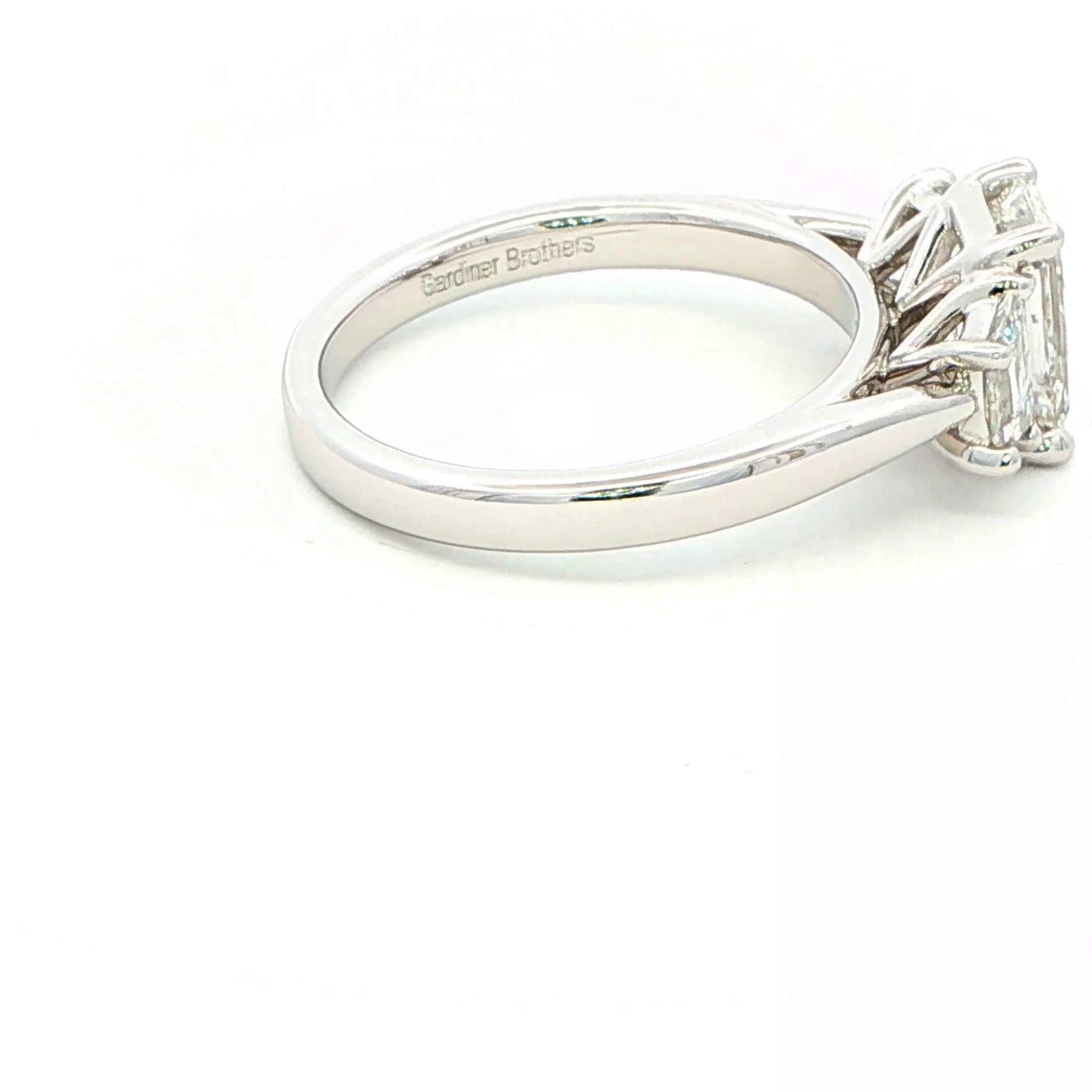Platinum Emerald and Trapezoid cut diamond 3 stone ring - 2.00cts Gardiner Brothers