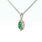 Oval Shaped emerald and round brilliant cut diamond cluster pendant