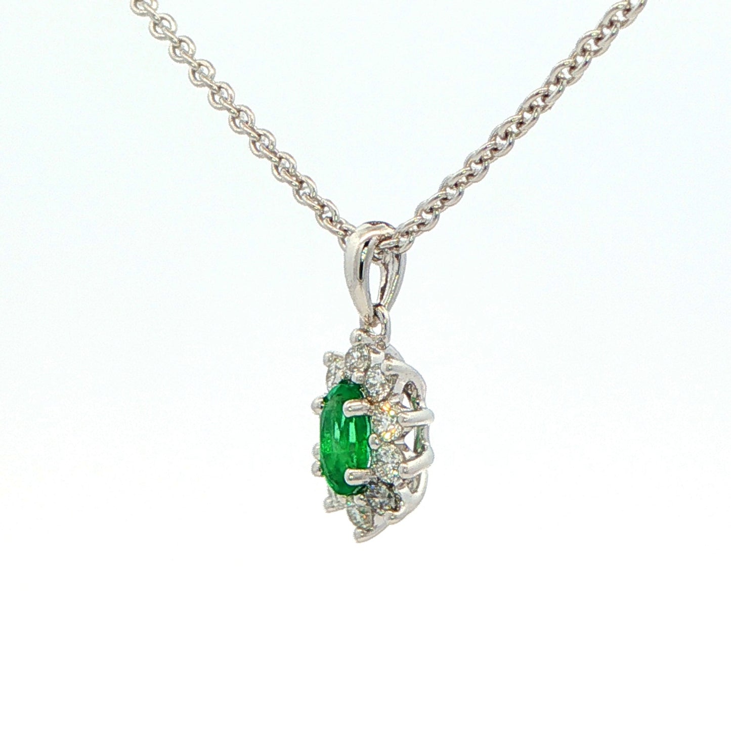 Oval Shaped emerald and round brilliant cut diamond cluster pendant