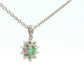 Oval Shaped emerald and round brilliant cut diamond cluster pendant