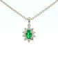 Oval Shaped emerald and round brilliant cut diamond cluster pendant