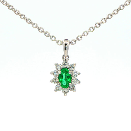 Oval Shaped emerald and round brilliant cut diamond cluster pendant