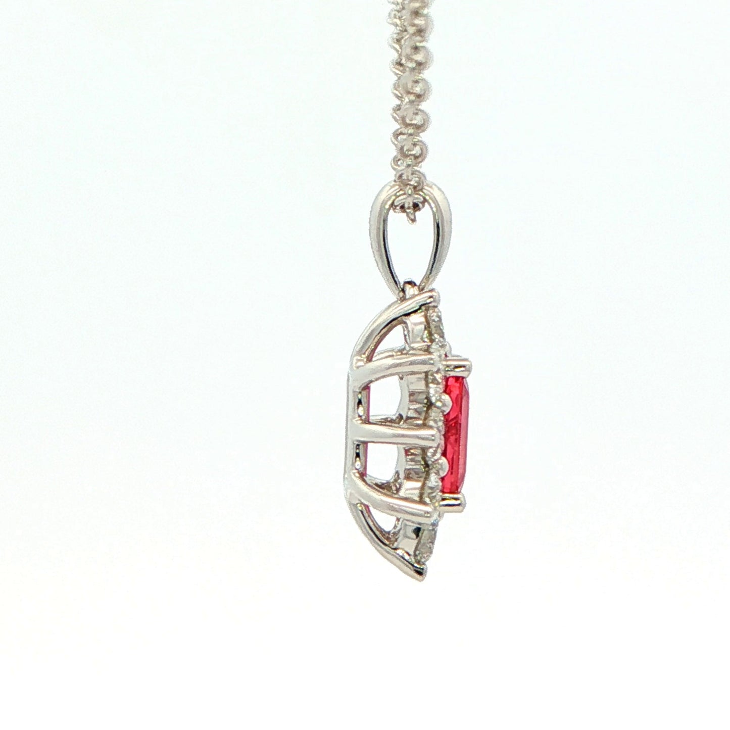 Octagonal shaped Ruby and round brilliant cut diamond cluster style pendant