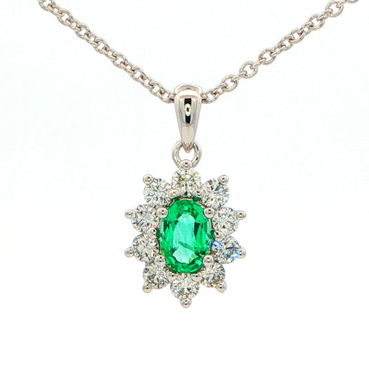 Oval shaped emerald and round brilliant cut diamond cluster pendant