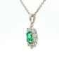 Oval shaped emerald and round brilliant cut diamond cluster pendant