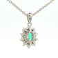 Oval shaped emerald and round brilliant cut diamond cluster pendant