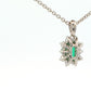 Octagonal shaped emerald and round brilliant cut diamond cluster pendant