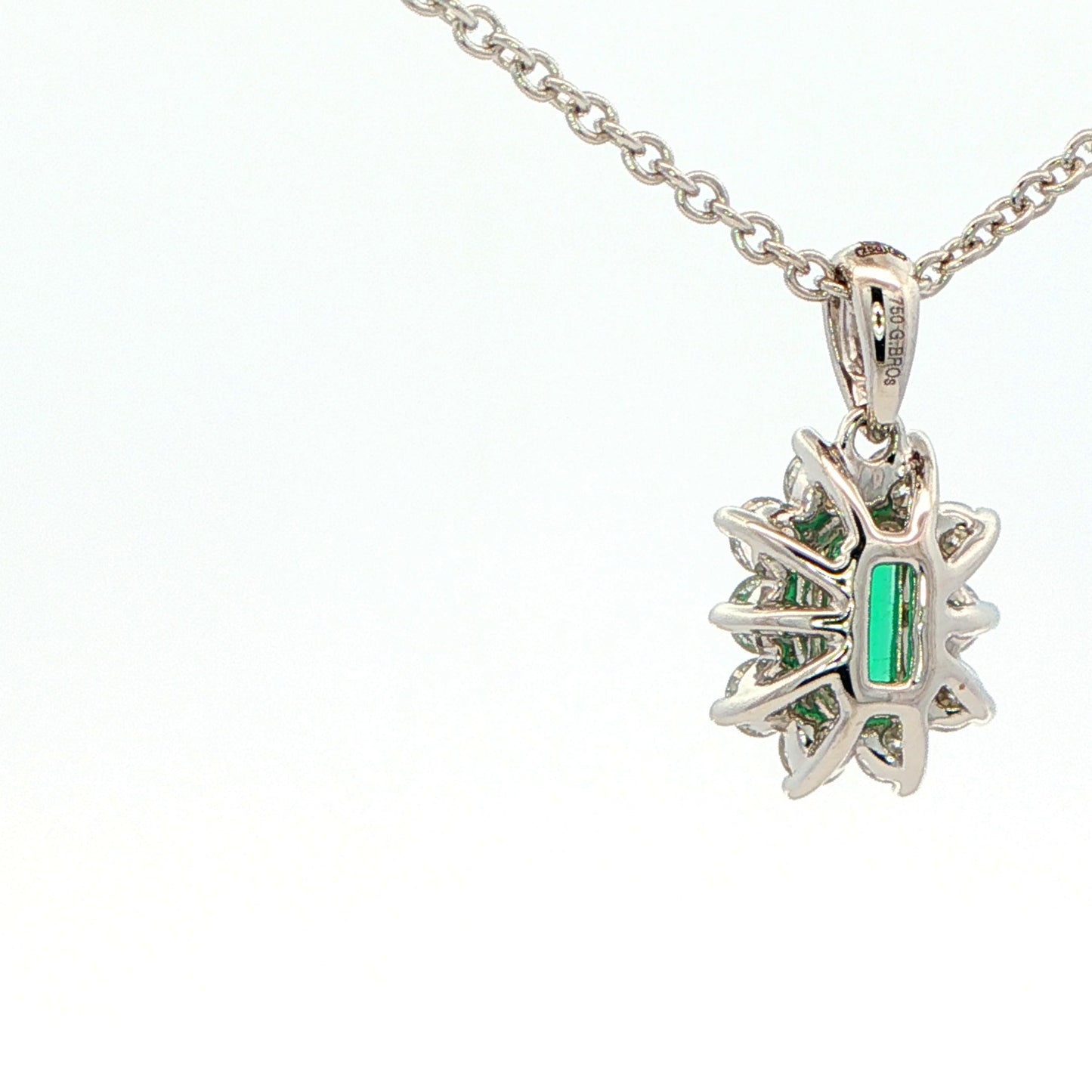 Octagonal shaped emerald and round brilliant cut diamond cluster pendant