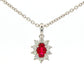 Oval shaped ruby and round brilliant cut diamond cluster style pendant