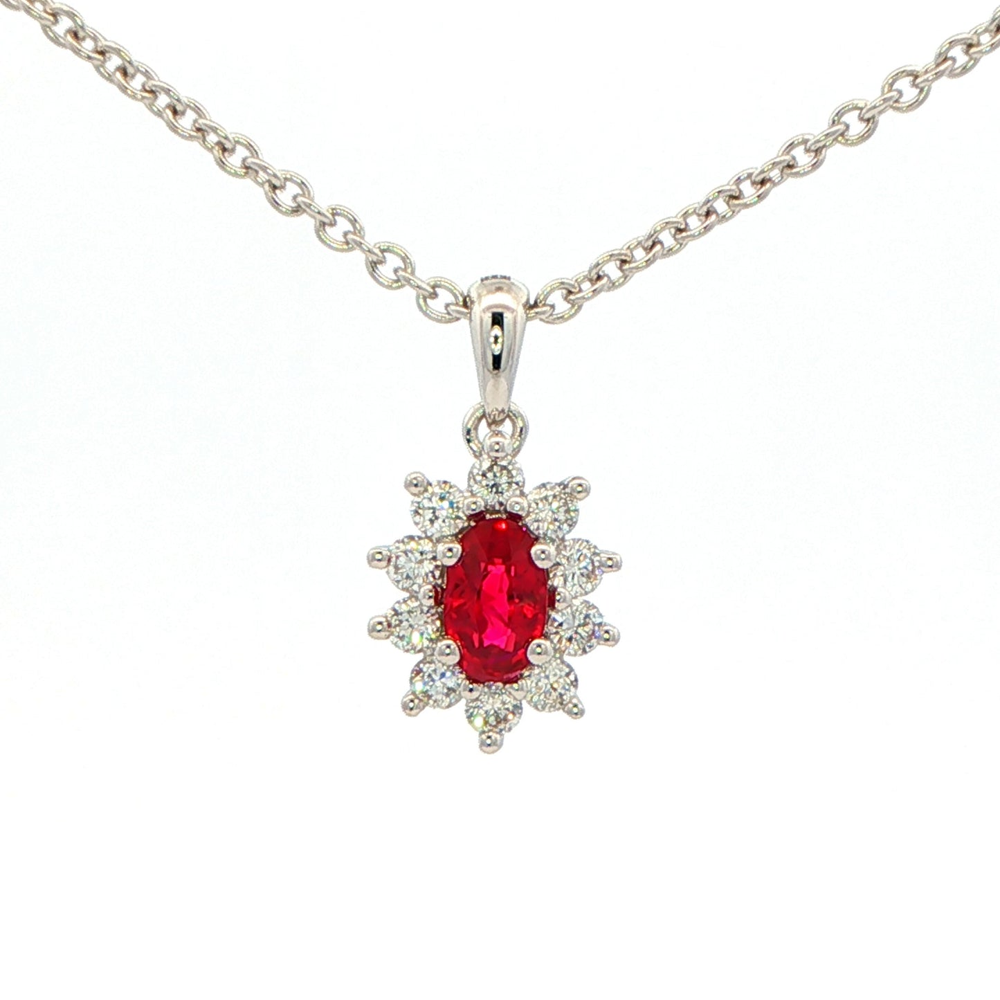 Oval shaped ruby and round brilliant cut diamond cluster style pendant