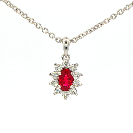 Oval shaped ruby and round brilliant cut diamond cluster style pendant