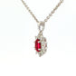 Oval shaped ruby and round brilliant cut diamond cluster style pendant