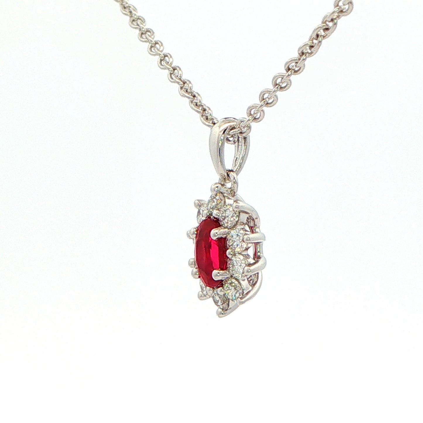 Oval shaped ruby and round brilliant cut diamond cluster style pendant