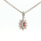 Oval shaped ruby and round brilliant cut diamond cluster style pendant