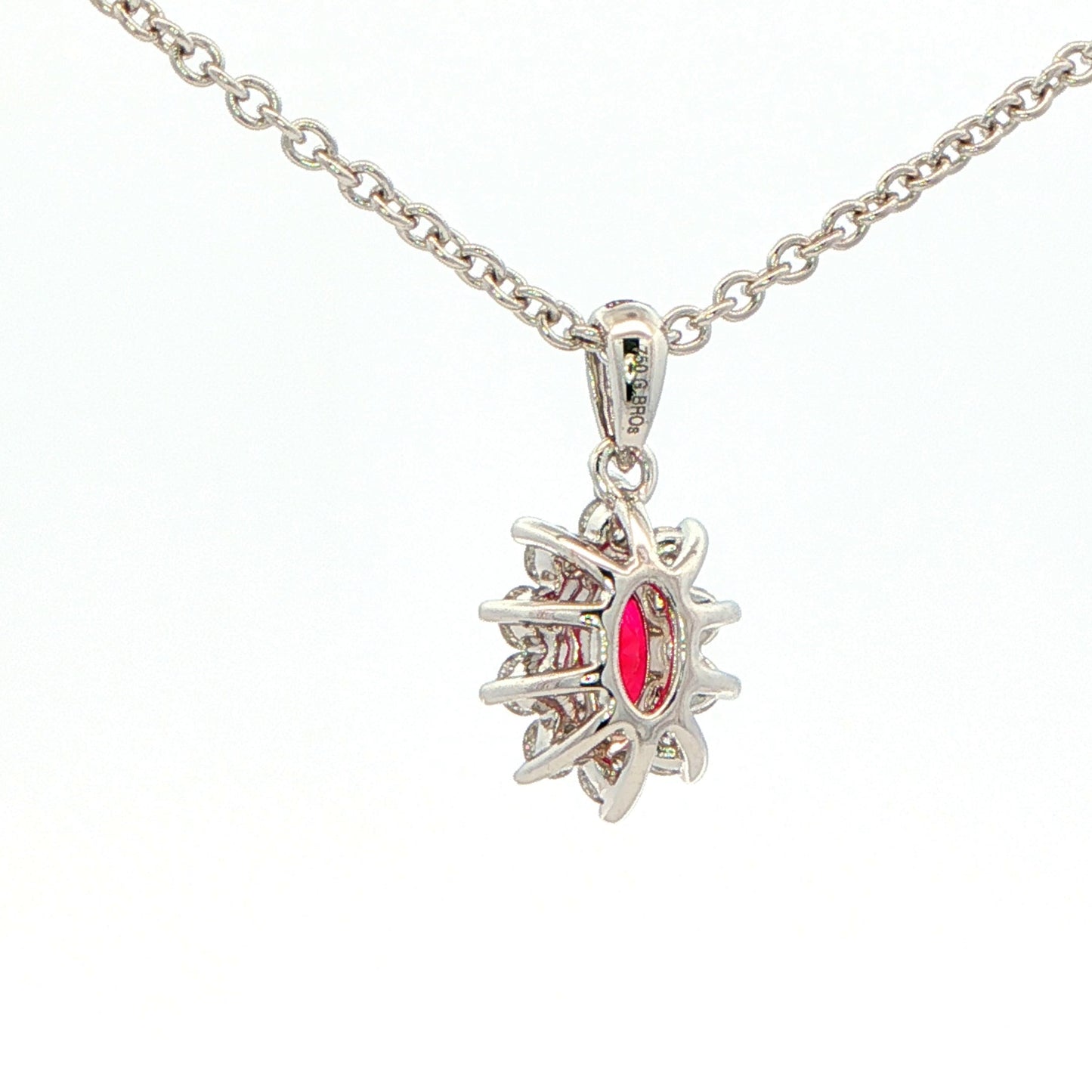 Oval shaped ruby and round brilliant cut diamond cluster style pendant