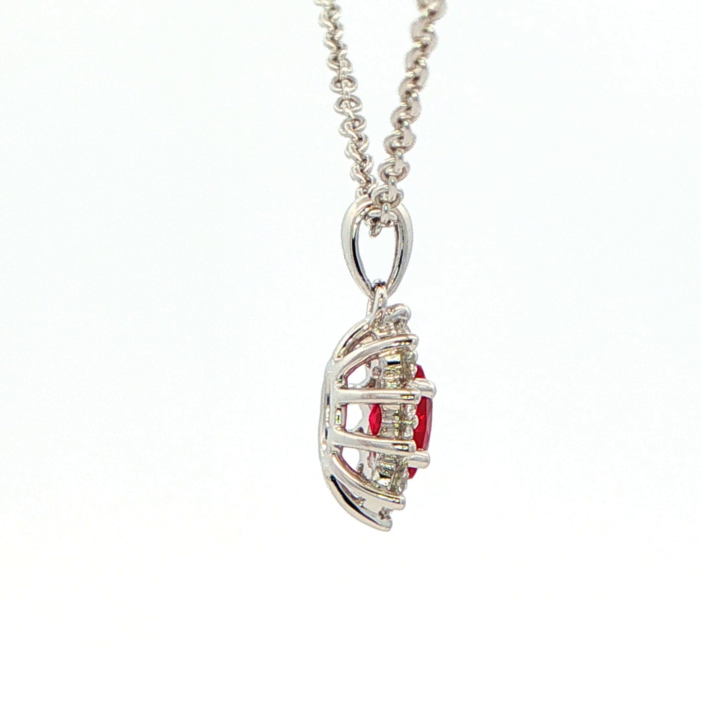 Oval shaped ruby and round brilliant cut diamond cluster style pendant