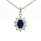 Oval shaped sapphire and round brilliant cut diamond cluster style pendant