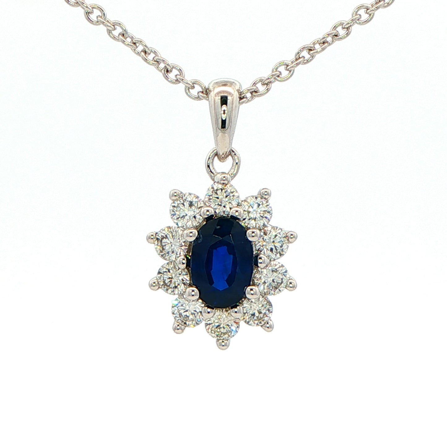 Oval shaped sapphire and round brilliant cut diamond cluster style pendant