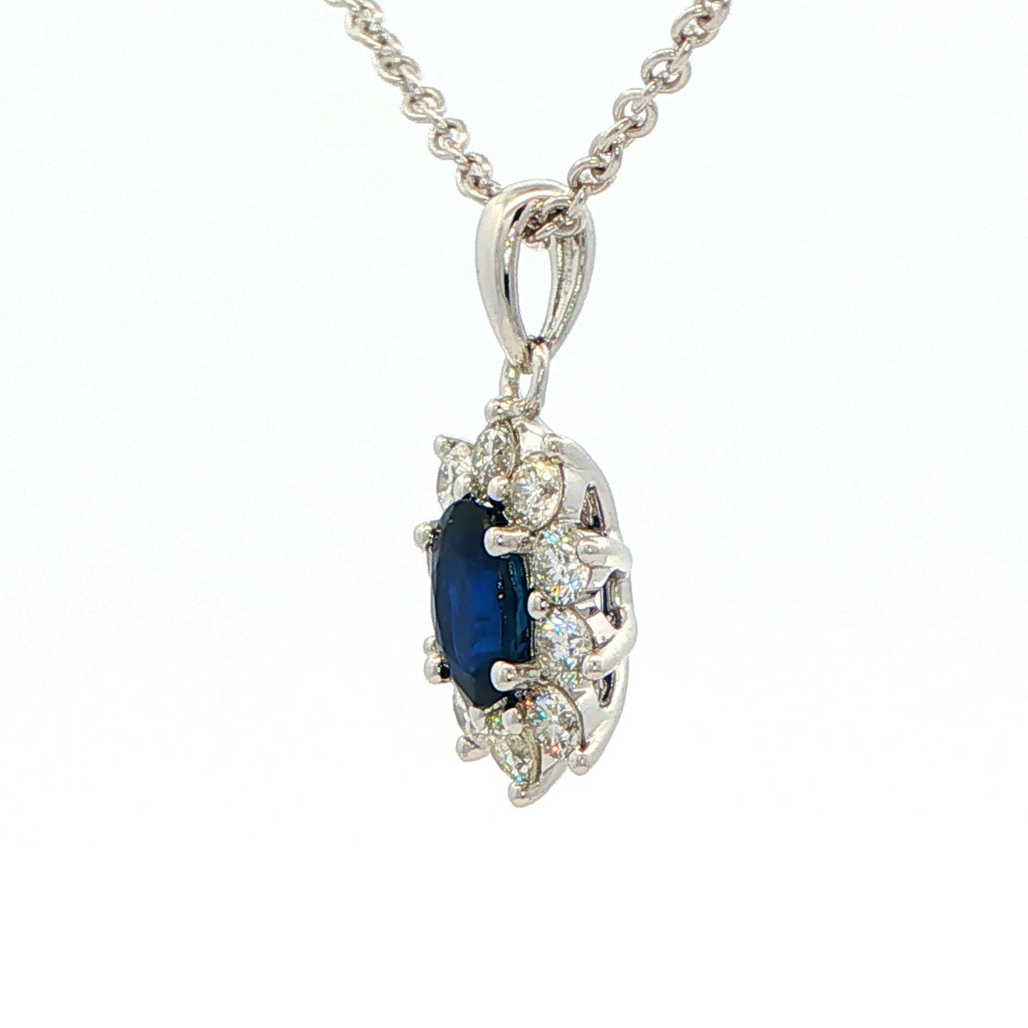 Oval shaped sapphire and round brilliant cut diamond cluster style pendant