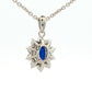 Oval shaped sapphire and round brilliant cut diamond cluster style pendant