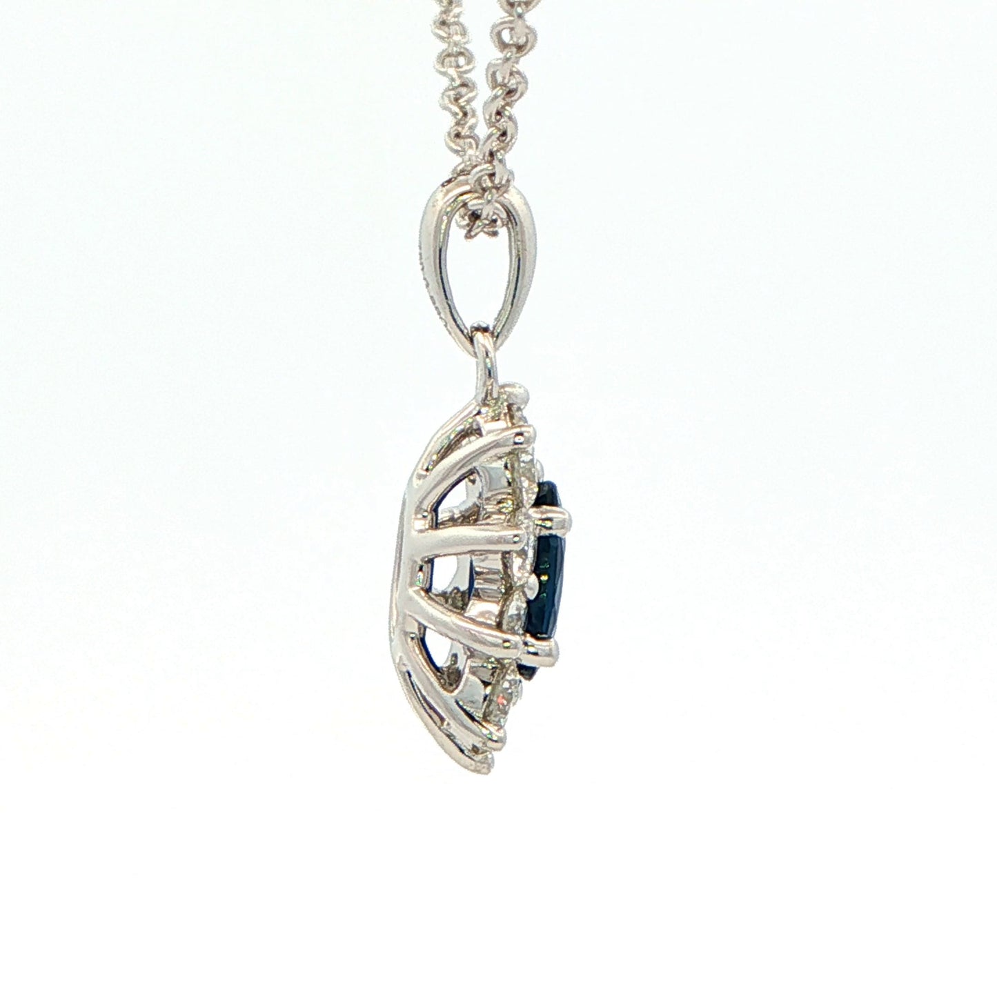 Oval shaped sapphire and round brilliant cut diamond cluster style pendant