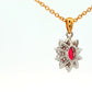 Oval shaped ruby and round brilliant cut diamond cluster style pendant