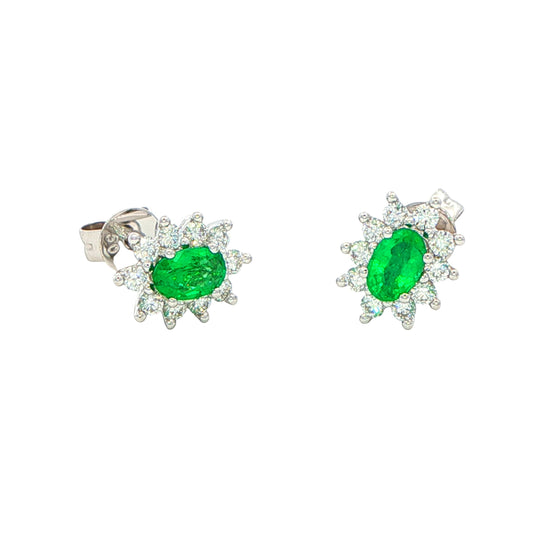 Oval shaped emerald and round brilliant cut diamond cluster style earrings