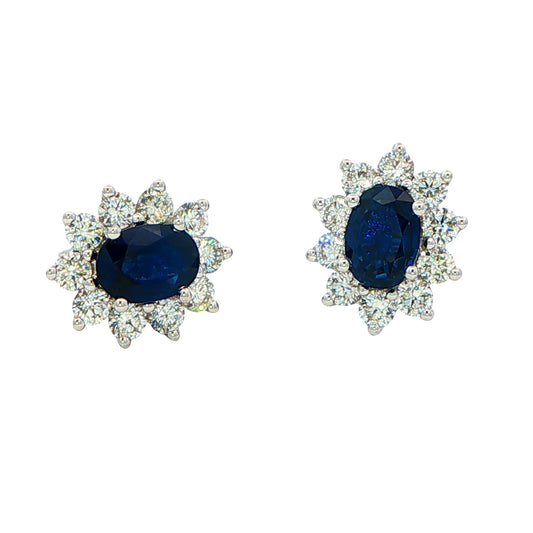 Oval shaped sapphire and round brilliant cut diamond cluster style earrings