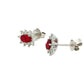 Oval shaped ruby and round brilliant cut diamond cluster style earrings