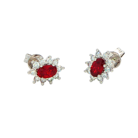 Oval shaped ruby and round brilliant cut diamond cluster style earrings