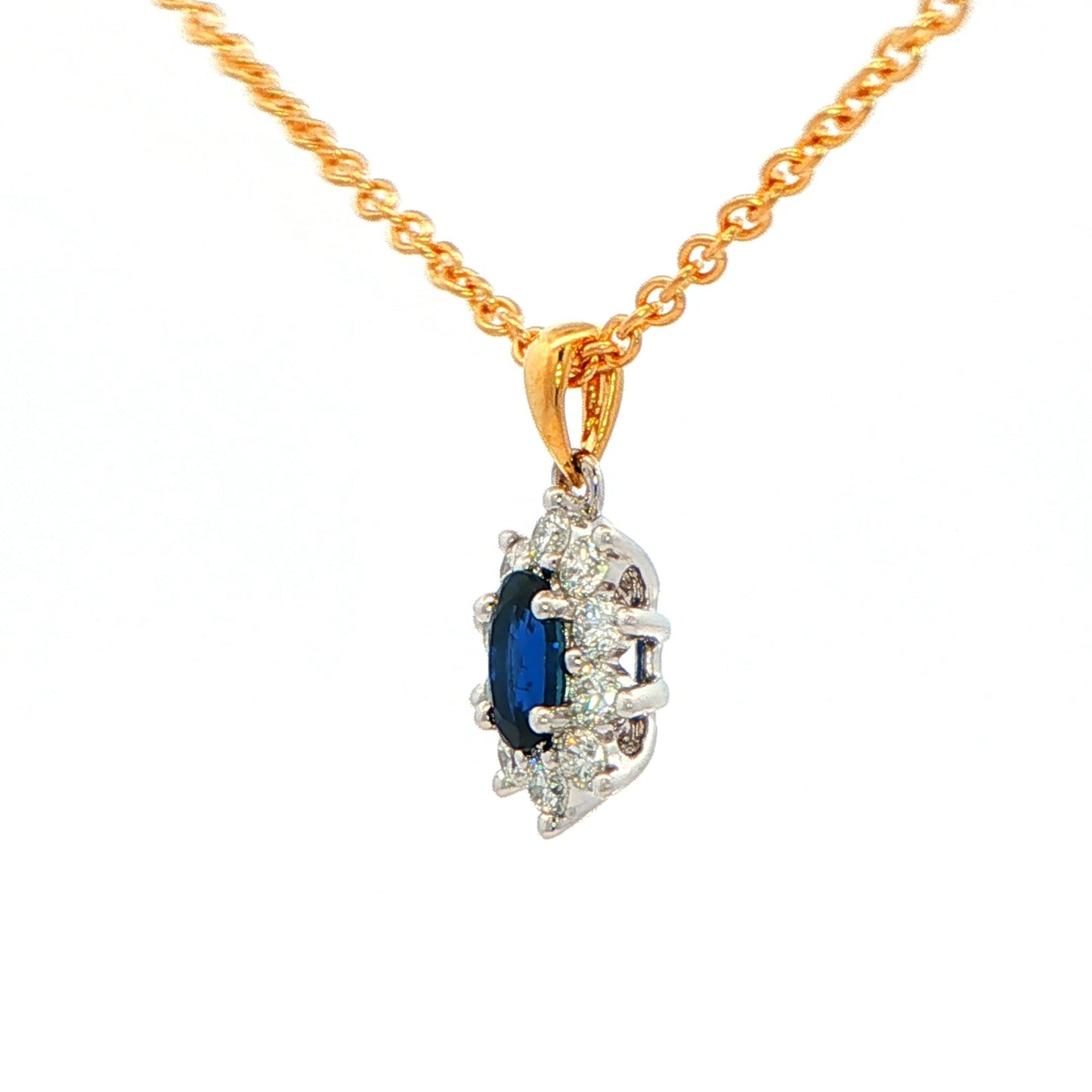 Oval shaped sapphire and round brilliant cut diamond cluster style pendant