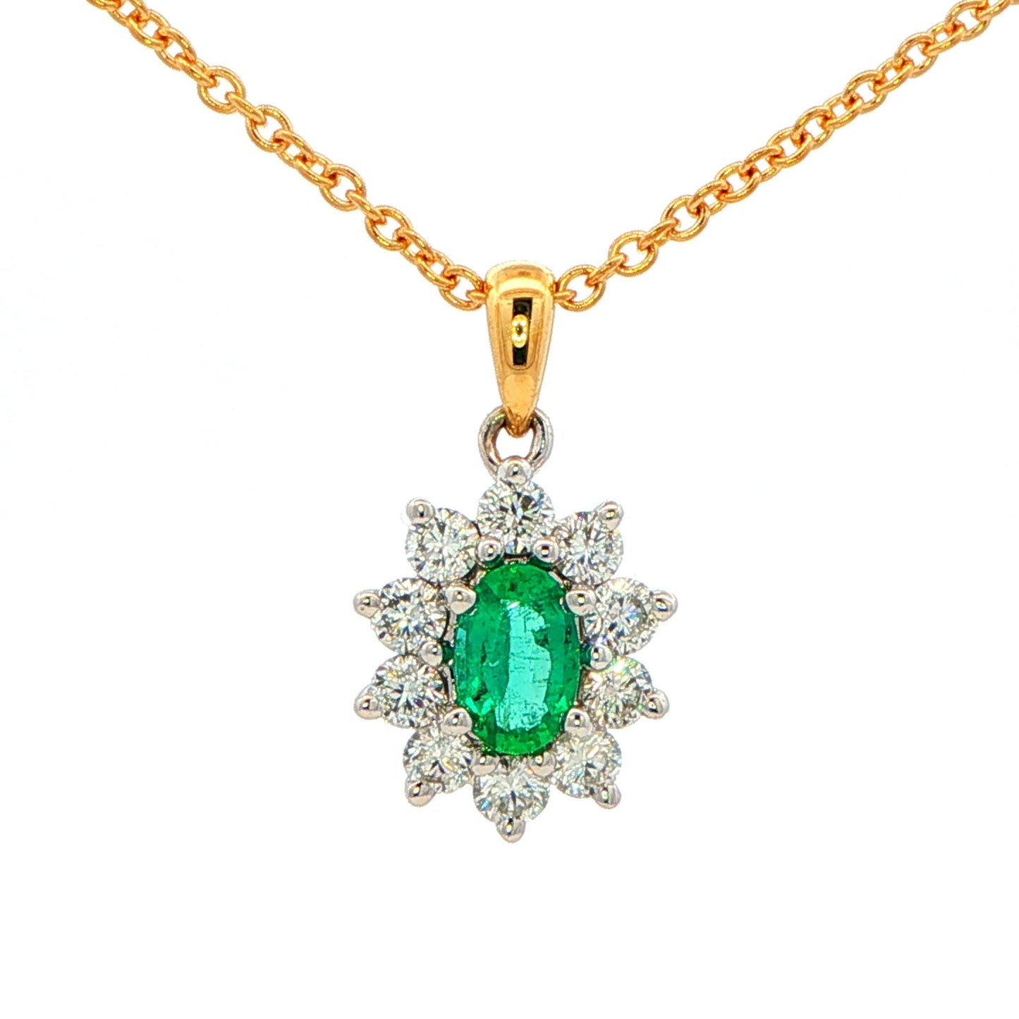 Oval shaped emerald and round brilliant cut diamond cluster style pendant