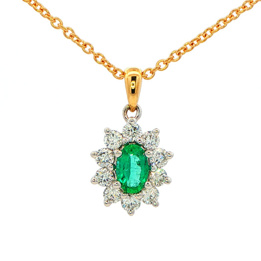 Oval shaped emerald and round brilliant cut diamond cluster style pendant