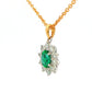 Oval shaped emerald and round brilliant cut diamond cluster style pendant