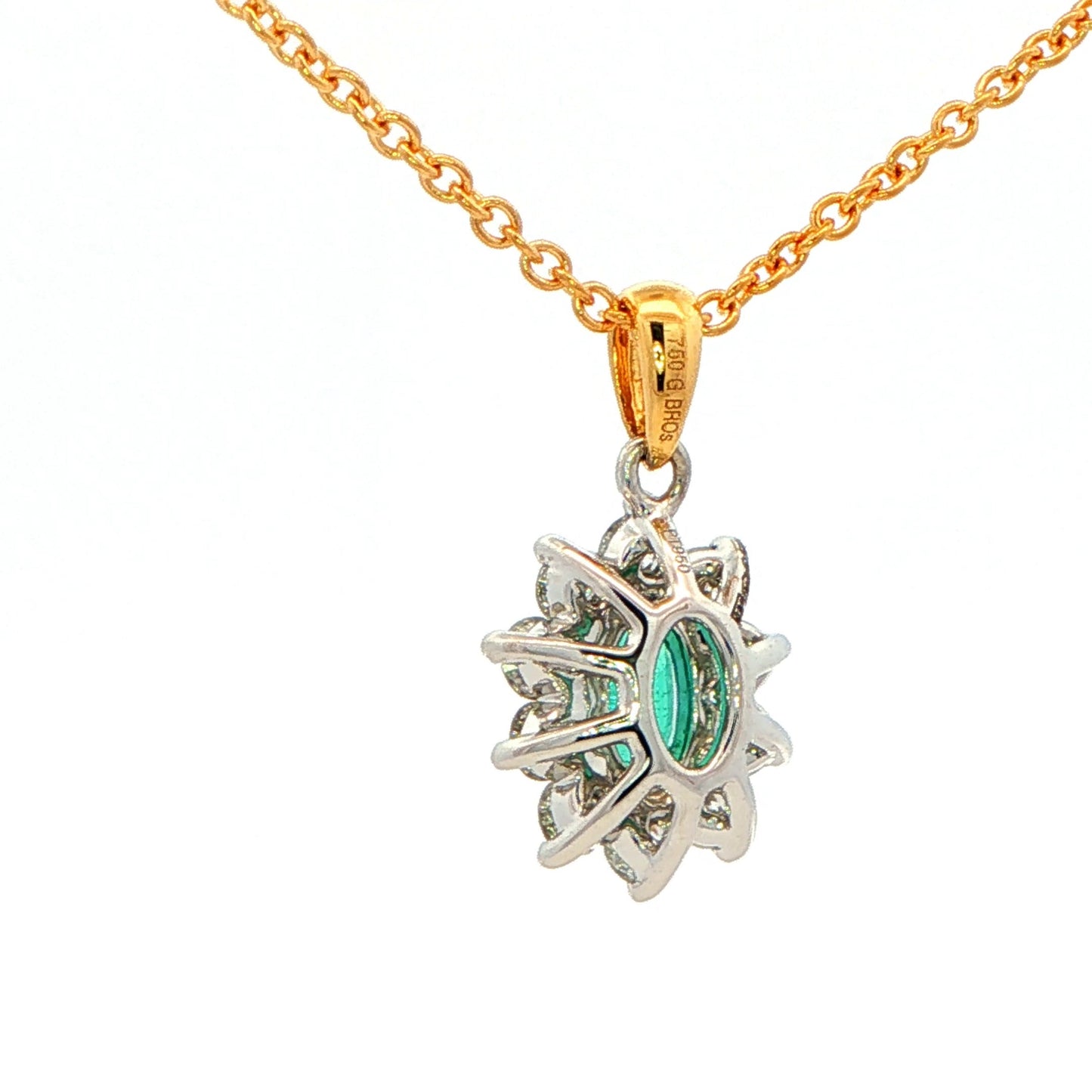 Oval shaped emerald and round brilliant cut diamond cluster style pendant