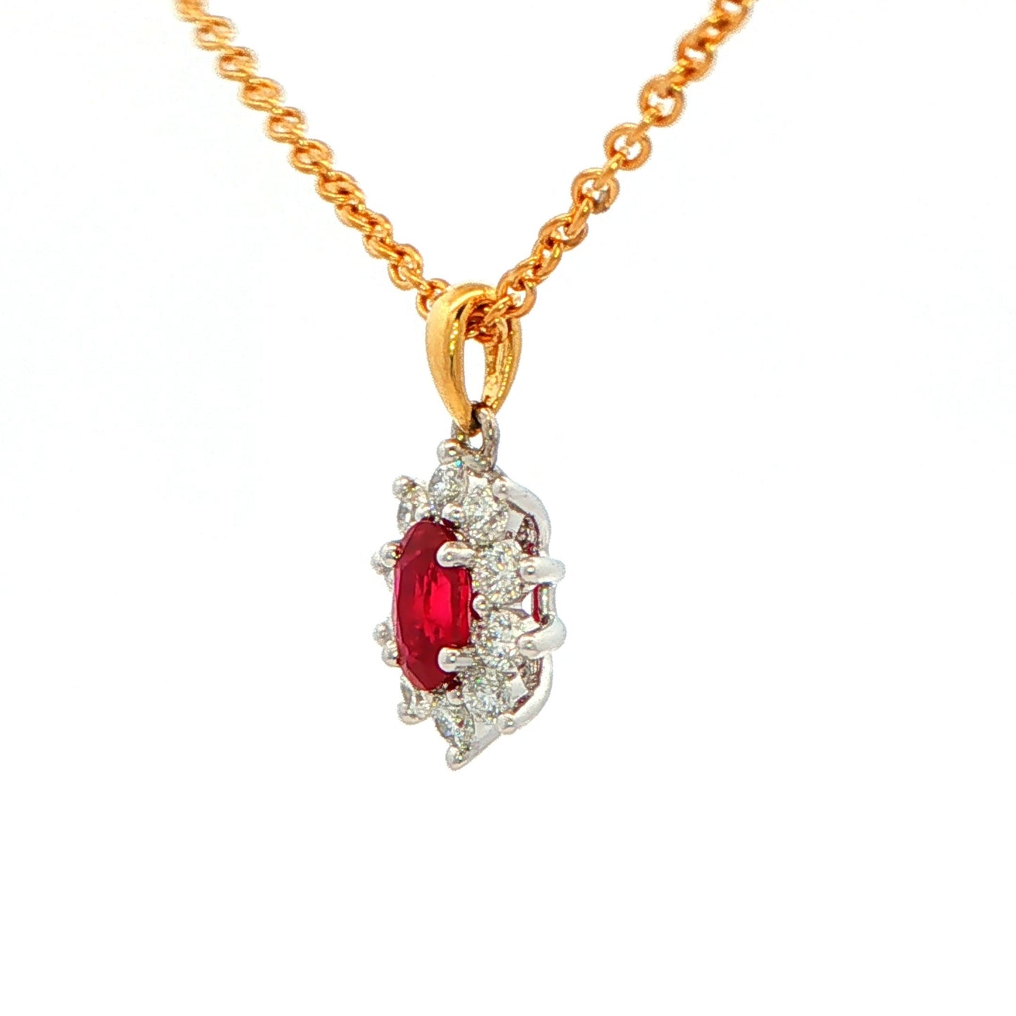 Oval shaped ruby and round brilliant cut diamond cluster style pendant