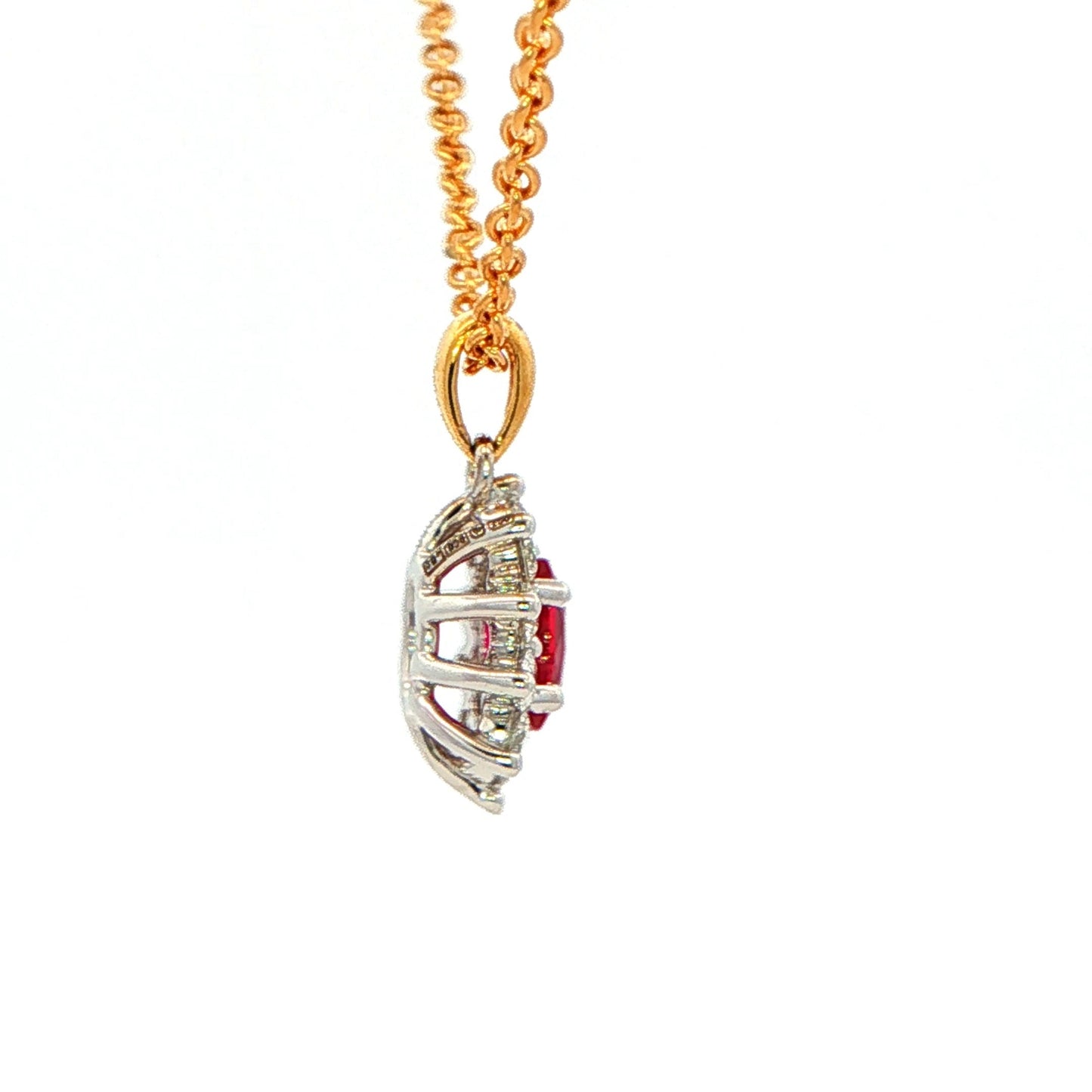 Oval shaped ruby and round brilliant cut diamond cluster style pendant