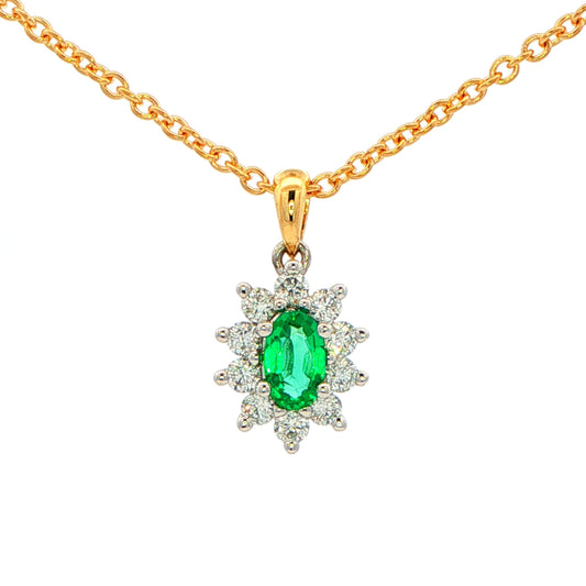 Oval shaped emerald and round brilliant cut diamond cluster style pendant