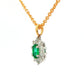 Oval shaped emerald and round brilliant cut diamond cluster style pendant