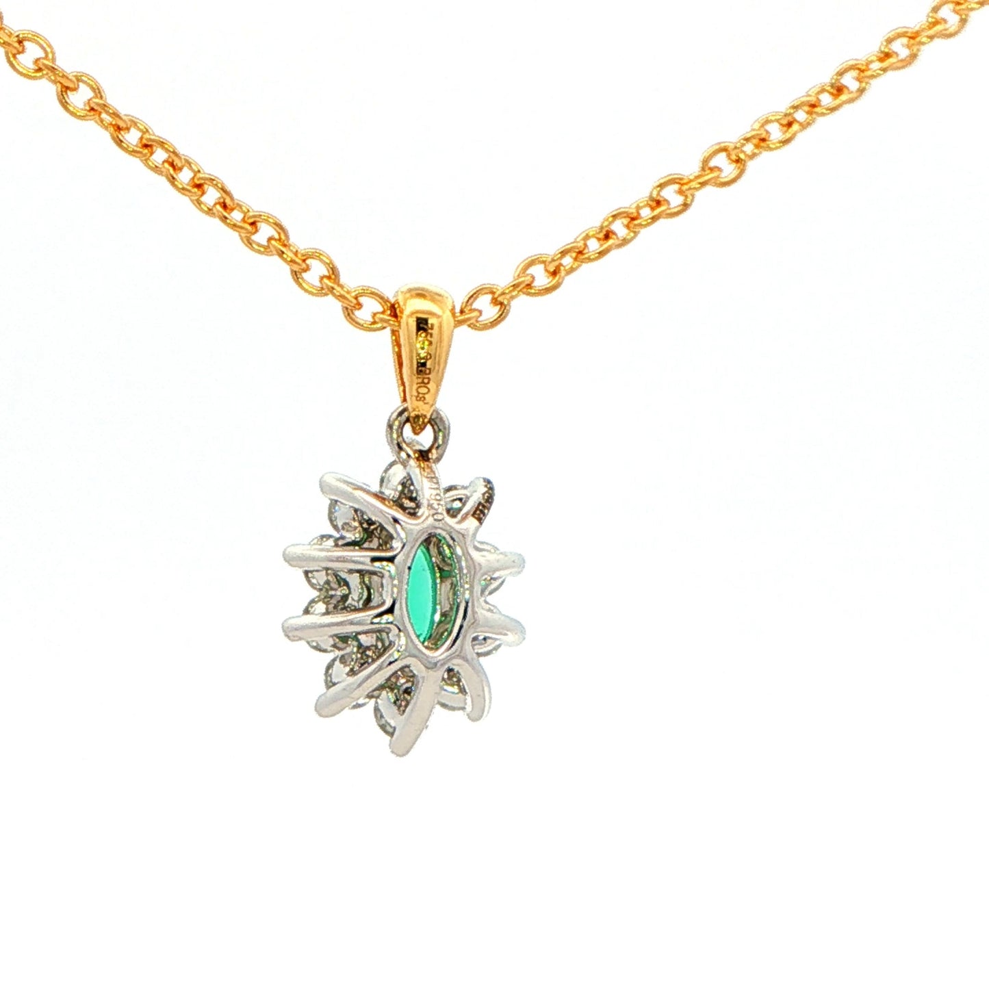 Oval shaped emerald and round brilliant cut diamond cluster style pendant