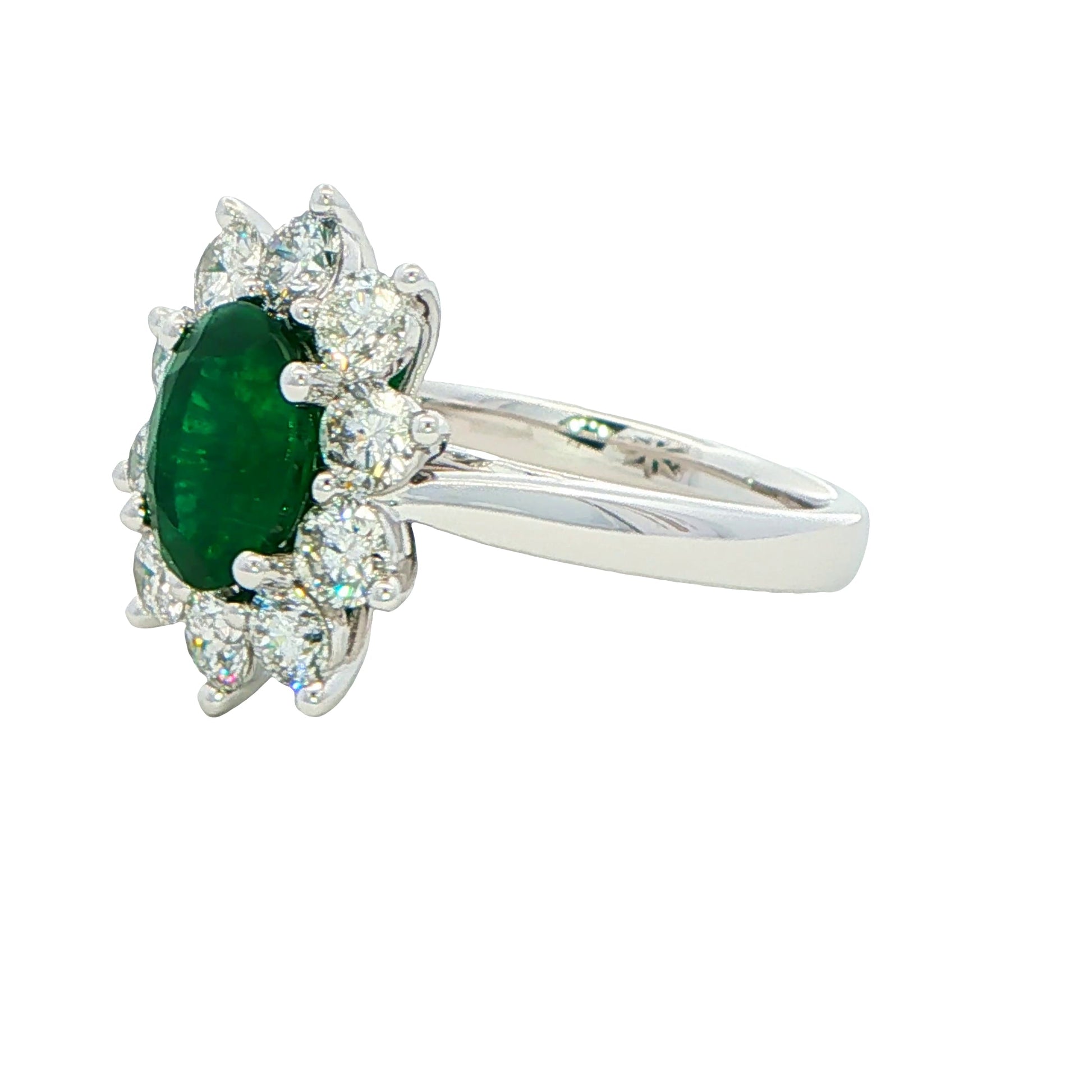 Oval shaped emerald and round brilliant cut diamond cluster style ring Gardiner Brothers